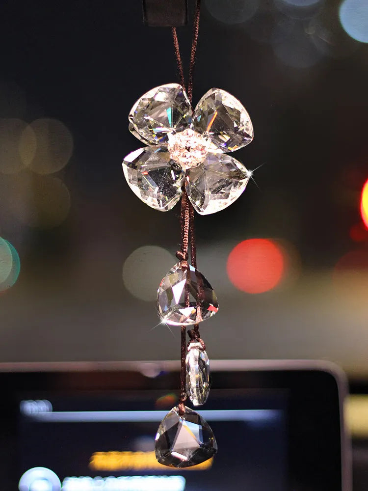 Crystal four leaf grass car pendant hanging, shown in different colour options including transparent and champagne.