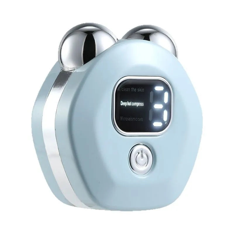 Portable white facial massager with hot compress function and double-roller head on a pink background.