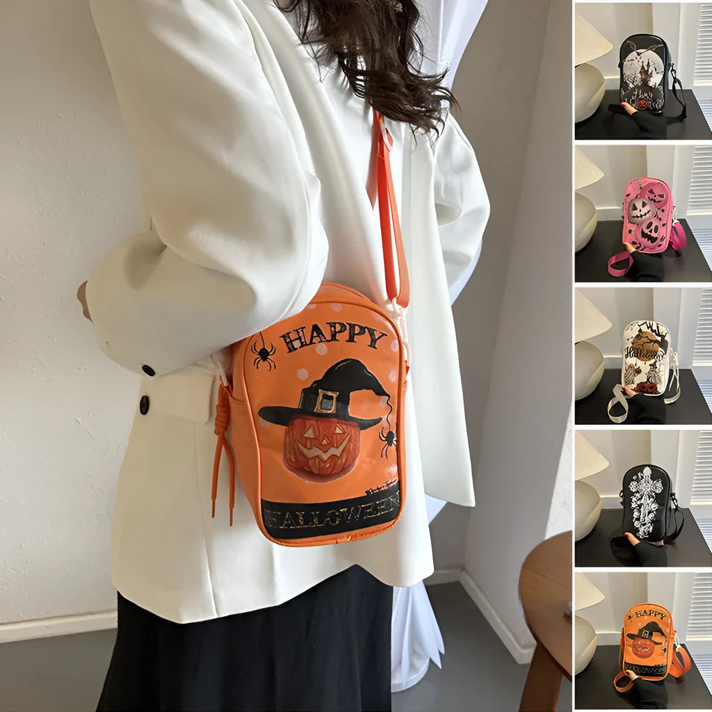Black Halloween crossbody bag with orange pumpkin, white ghost, and bat graffiti print, shown worn across the body.