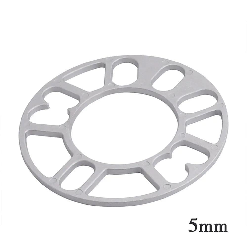 Set of four metal wheel hub widening gaskets in 3mm, 5mm, 8mm, and 10mm thicknesses for automotive modification.