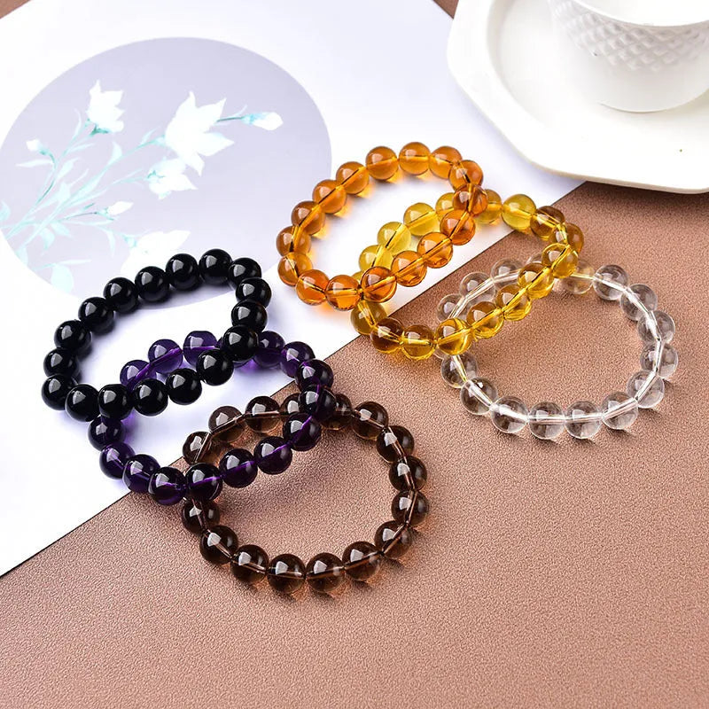 Geometric glass bead bracelet in obsidian, amethyst, citrine, or white crystal on a white background.
