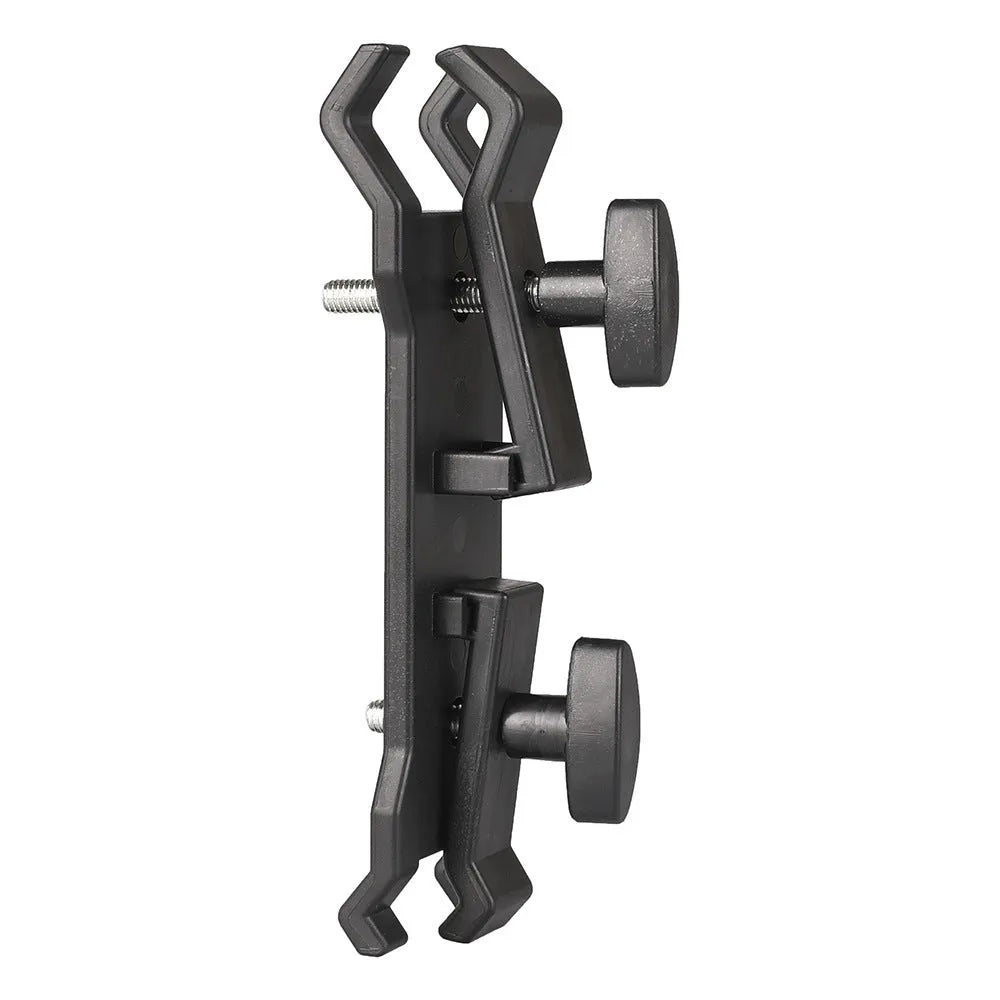 Black plastic umbrella clip attached to a tripod leg, holding a folded umbrella.