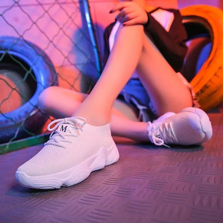 Women's white thick-soled sports shoes with flying woven upper and front strap.