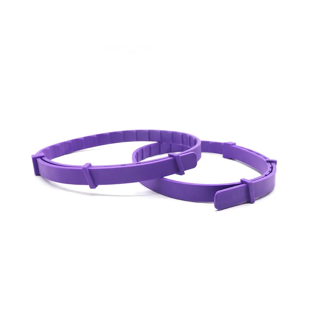A pack of four solid-colour dog anxiety relief collars made from black, blue, grey, and pink TPR, each measuring 62cm.