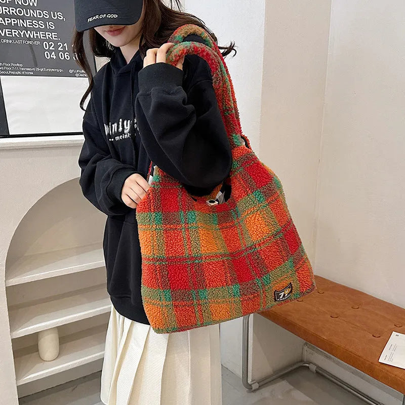 Women's plaid pattern plush crossbody tote bag showing interior zipper compartment and strap design