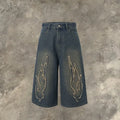 Men's black cropped denim shorts with flame embroidery patch on leg