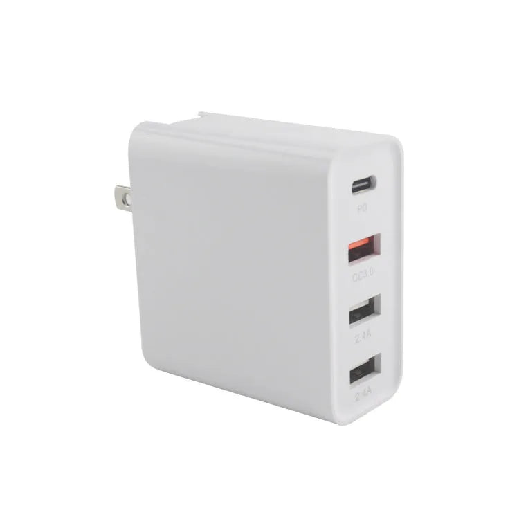 Black 48W USB-C four-port fast wall charger with UK plug on a wooden surface