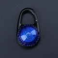 Pink LED flashing pet safety pendant clipped onto a collar with CR2032 batteries, showing 57x33mm ABS water-resistant build