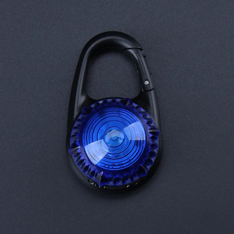 Pink LED flashing pet safety pendant clipped onto a collar with CR2032 batteries, showing 57x33mm ABS water-resistant build