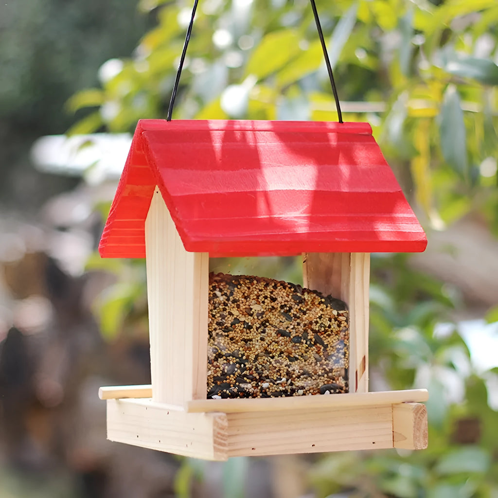 Suspended pine wood bird feeder with a red roof and log texture.