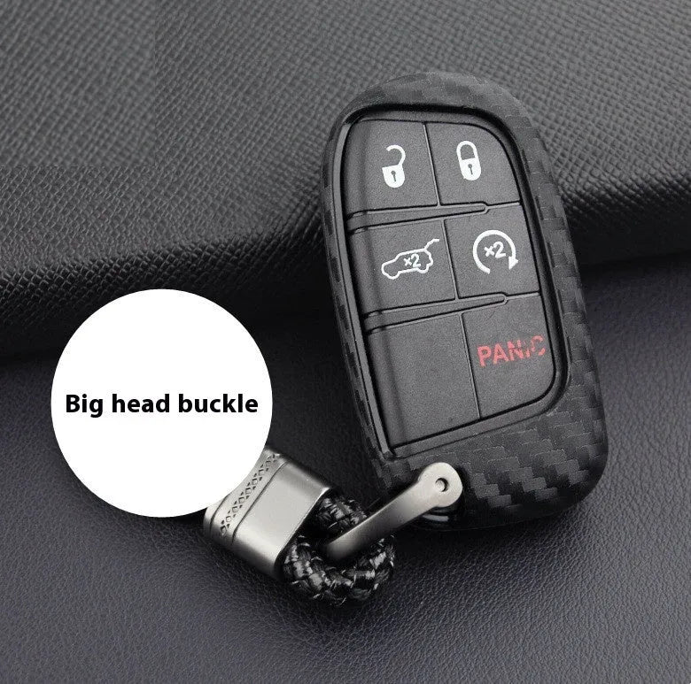 Black silicone protective case covering a Dodge car key fob, shown next to an unbuckled version.