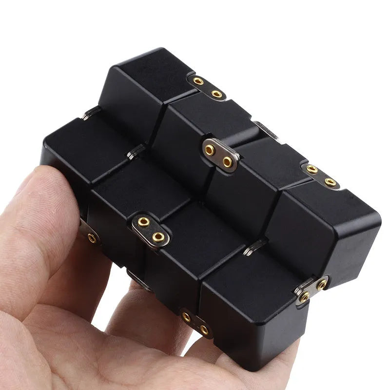 Black zinc alloy infinity cube fidget toy showing rotated cubes, on a white background.