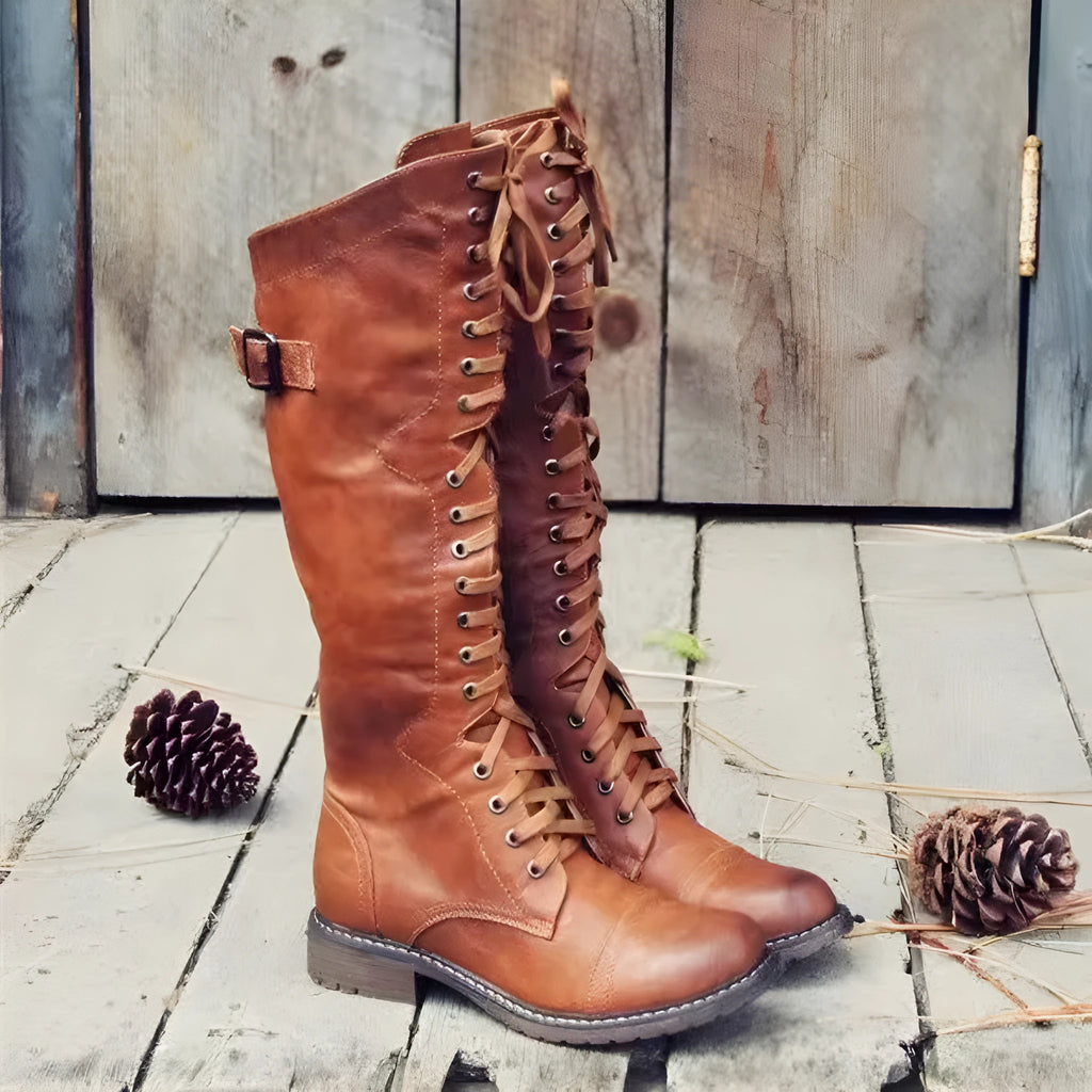 Black chunky heel high leg boots on a white background, showing round toe and stout low heel.