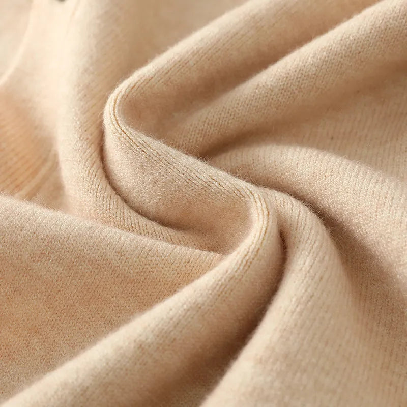 Man wearing a beige Andy velvet V-neck cardigan coat with long sleeves.