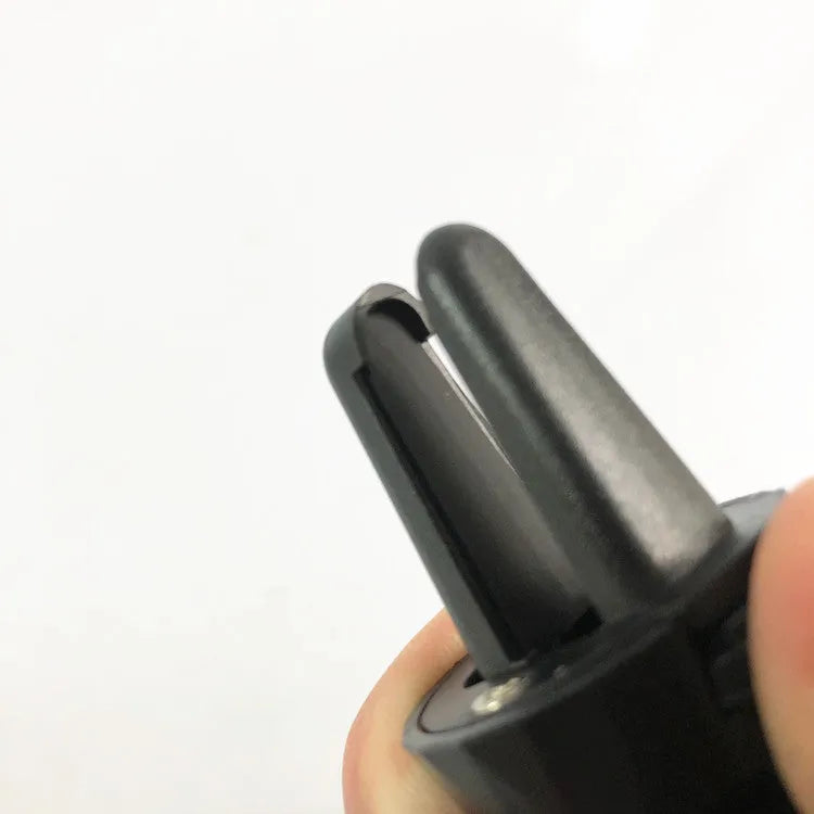Matte black car phone holder mounted on air outlet with adjustable clamp and 360-degree rotation