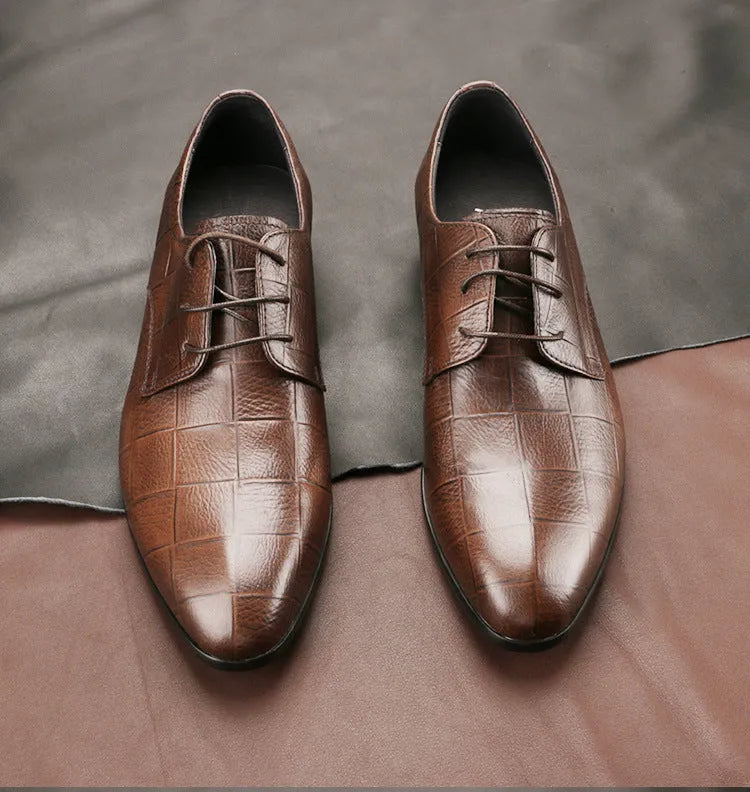 Men's black checkered leather derby shoes with a pointed toe and rubber sole on a white background.