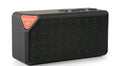 Small cube-shaped wireless Bluetooth speaker in multiple colours showing its compact, waterproof design