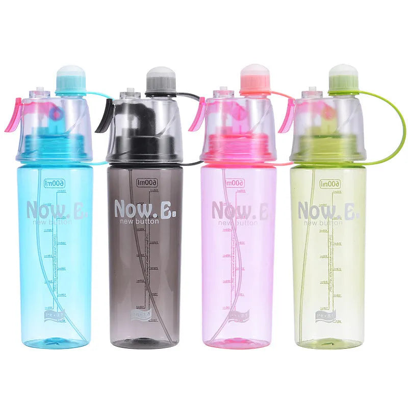 Green portable sports mist spray cup with transparent body, scale markings, and a black spray mouth cap.