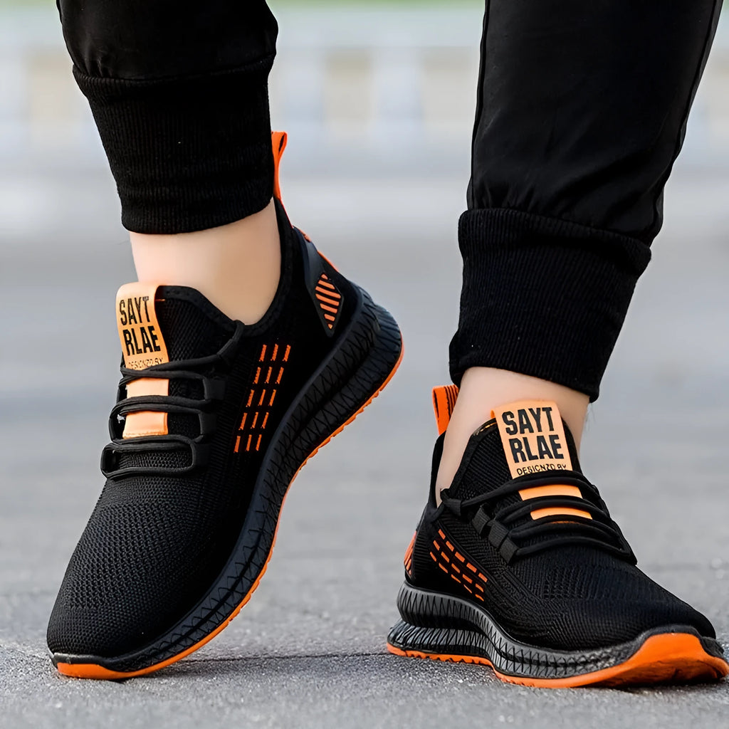 Men's black casual sports shoes with cross strap and flying weave upper on a white background