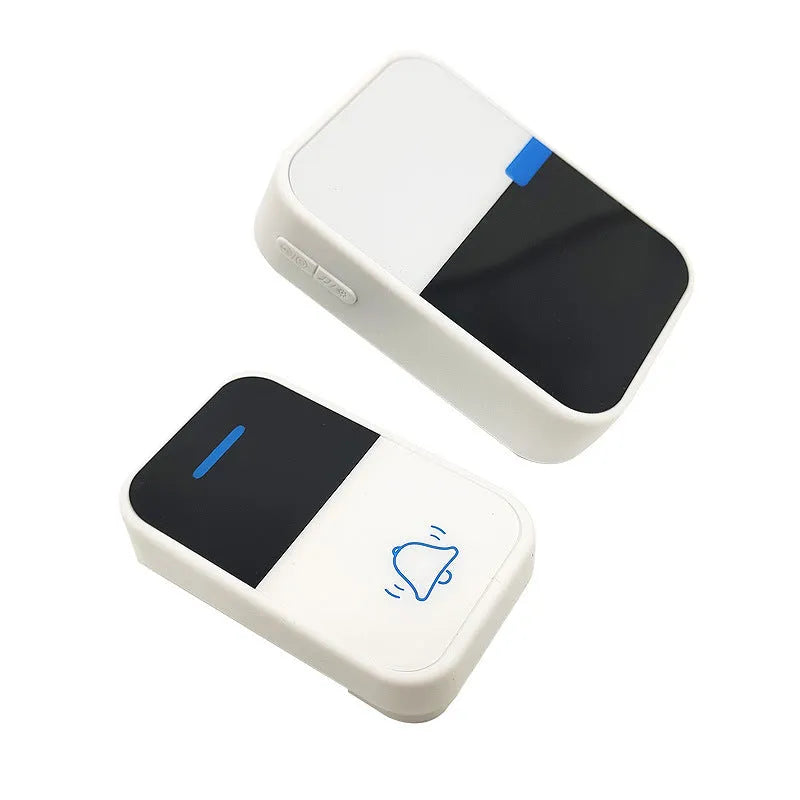 White self-powered wireless doorbell transmitter and plug-in receiver on a wooden table.