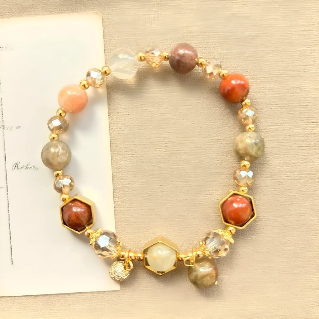 Gold citrine crystal bracelet with Fu character, safety lock, and cloud pattern charms on wrist
