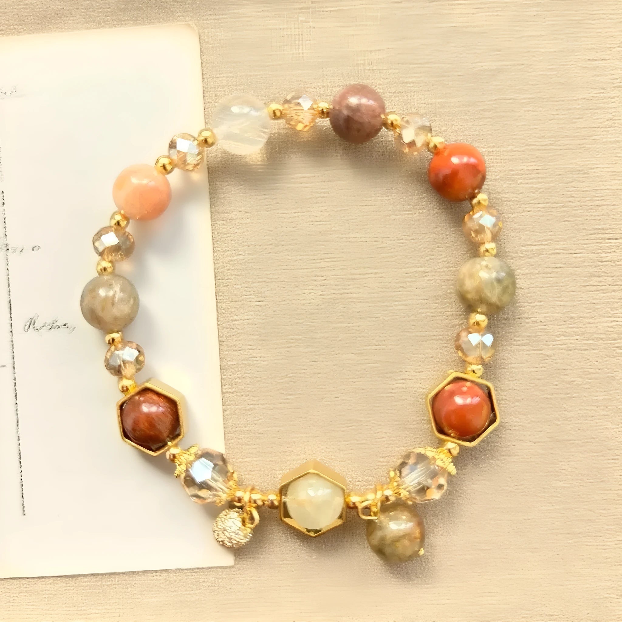 Gold citrine crystal bracelet with Fu character, safety lock, and cloud pattern charms on wrist