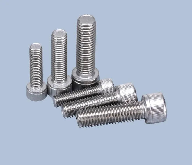 Stainless steel phono cartridge mounting kit with allen bolts, nuts, washers, and two allen keys on a grey background.