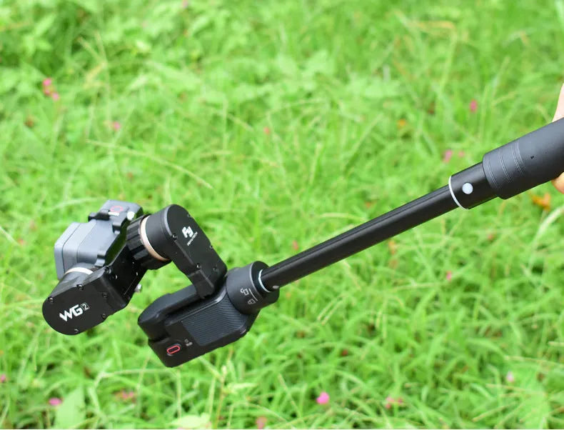 Retractable metal selfie stick with rubberised grip handle and smartphone mount, shown extended.
