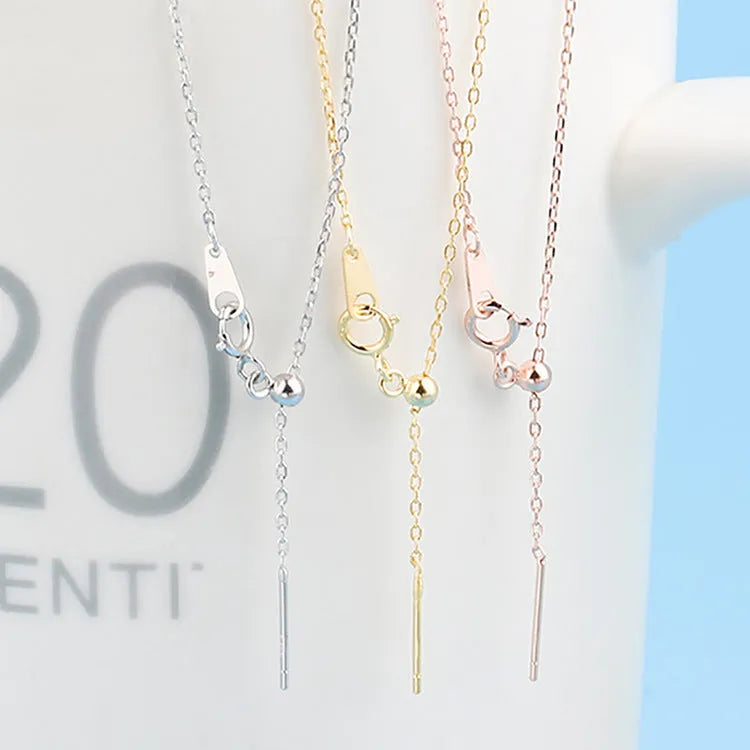 Stainless steel necklace with a U-shaped pendant on a chain, shown in steel, gold, and rose gold colour options.