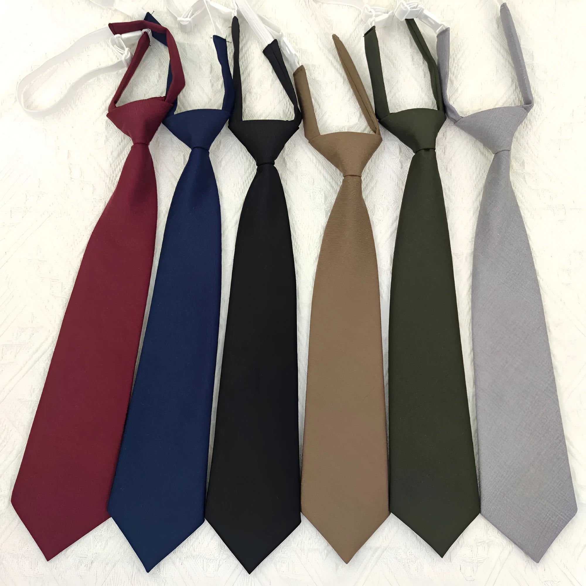 Men's arrow-style cotton bow tie in navy blue with tie-dye texture, laid flat showing its 35cm length.
