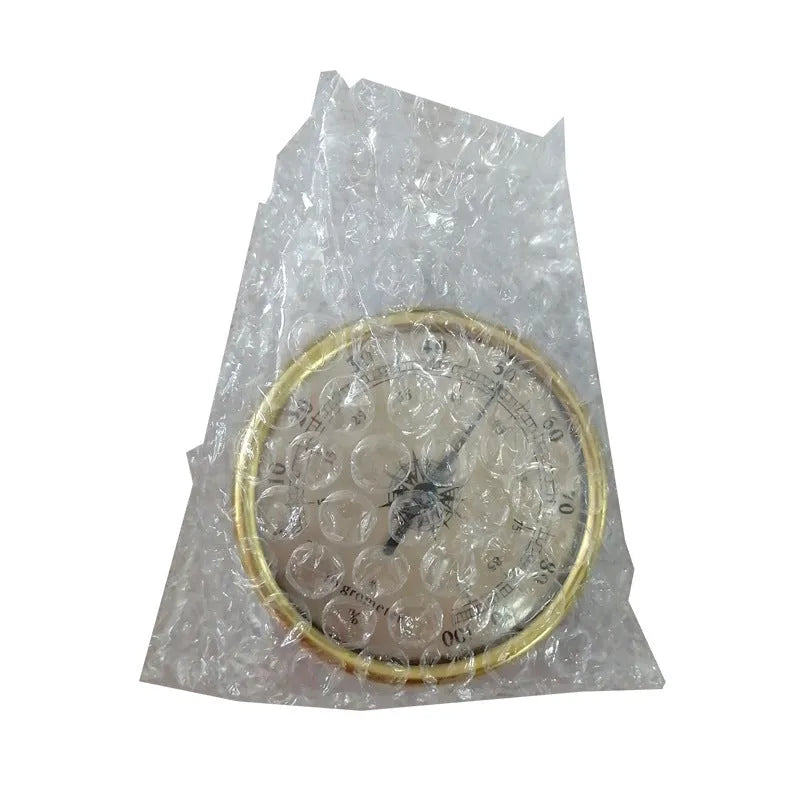 Analogue thermometer and hygrometer with aluminium dial on white background