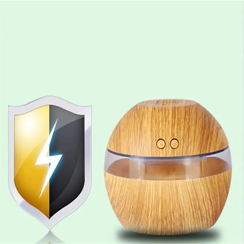 Brown wood grain portable USB humidifier on a desk next to a laptop.