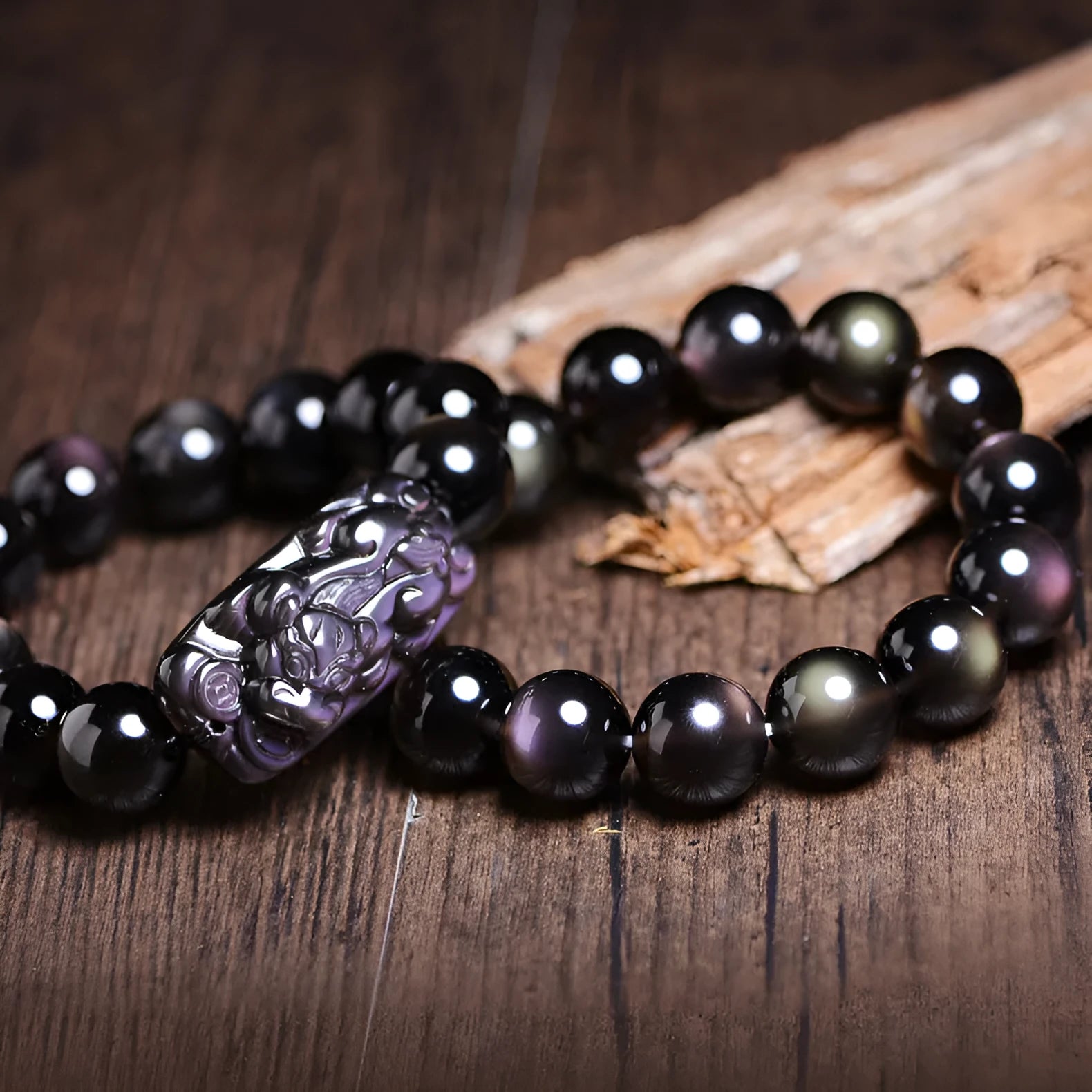 Polished crystal Pi Xiu bracelet with geometric beads on wrist, showing ice stone colour.