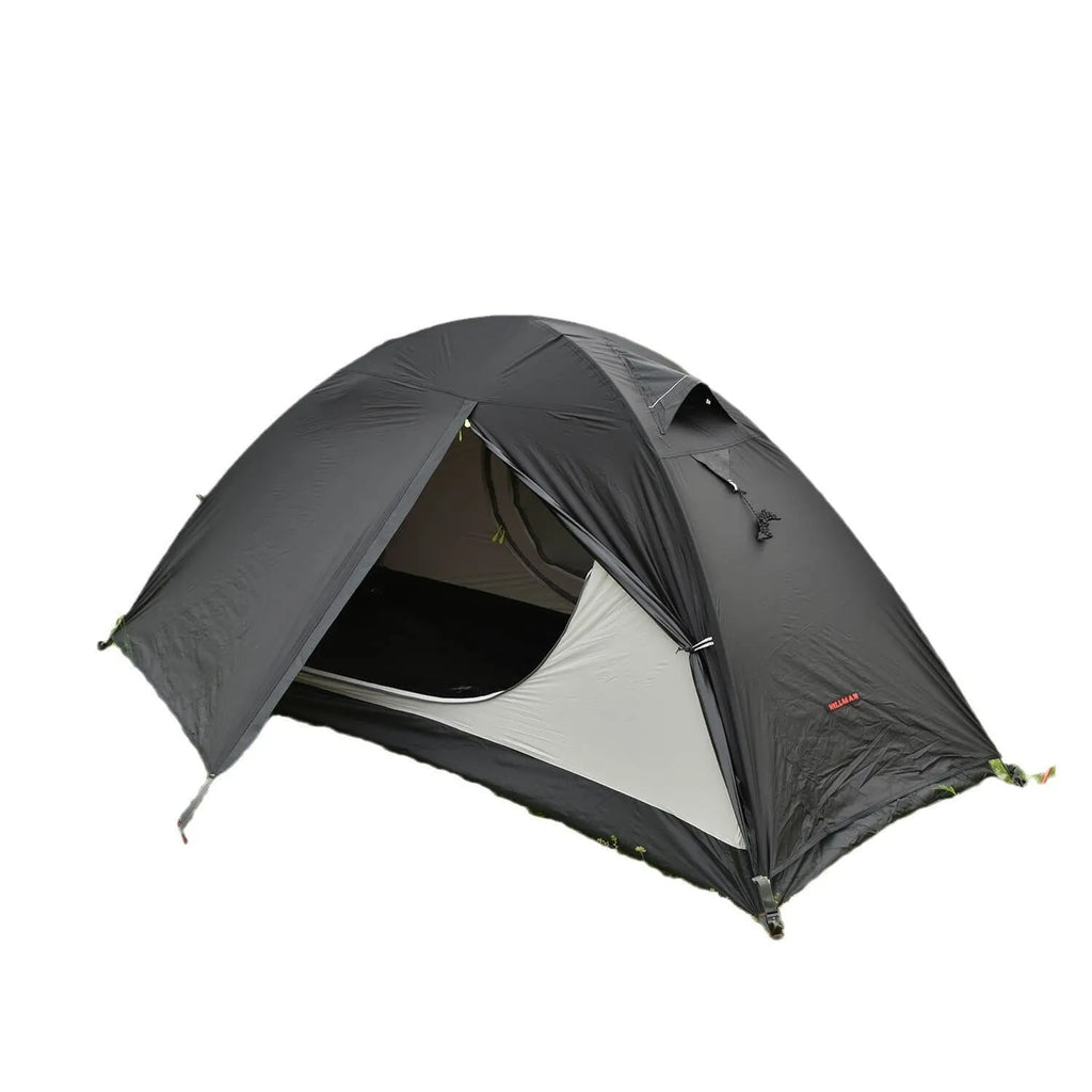 Single person green tunnel tent with aluminium poles pitched in a forest, showing mesh door and waterproof flysheet.