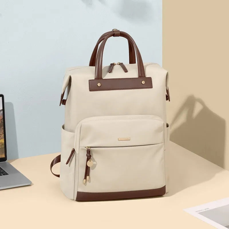 Large apricot coloured backpack with adjustable straps on a grey background