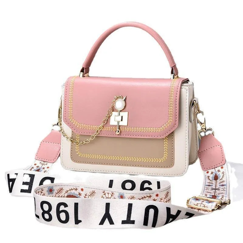 Large capacity PU shoulder bag with wide strap, embroidery detail, and contrast colour in black