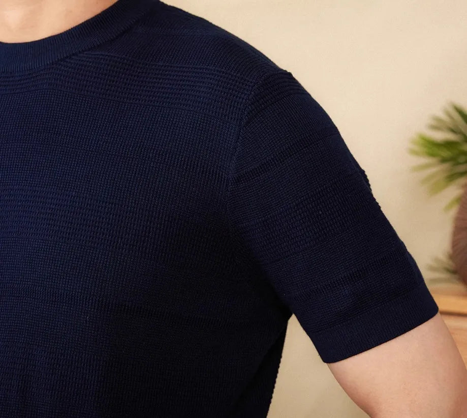 Men's off-white pure cotton short sleeve t-shirt with a round neck, laid flat on a surface.