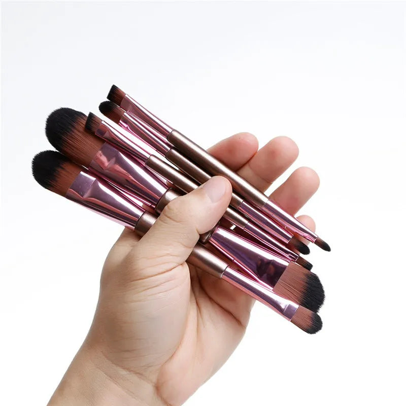 Rose gold double-ended makeup brush set of five with synthetic bristles on white background