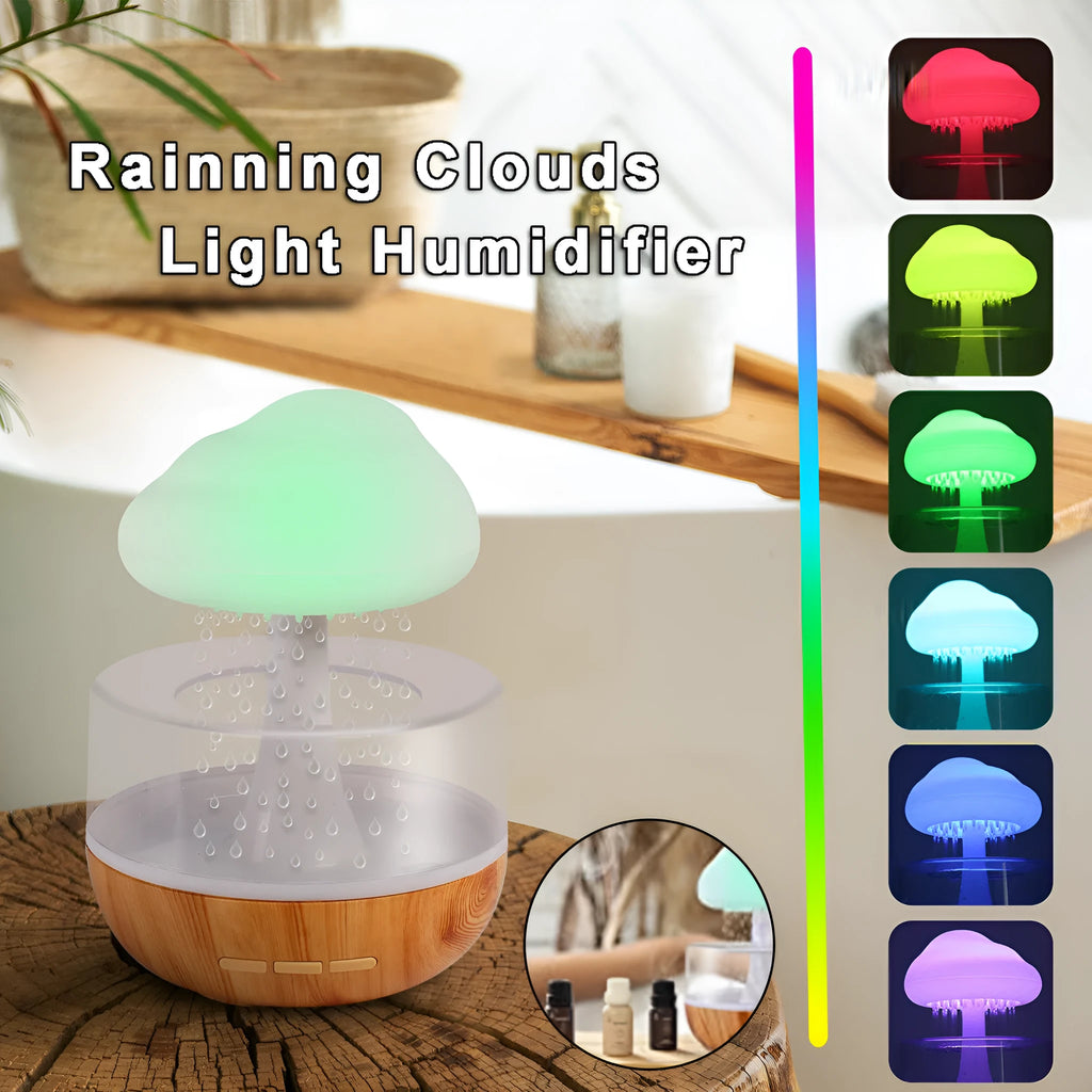 White cloud-shaped humidifier and essential oil diffuser with coloured mood light on.