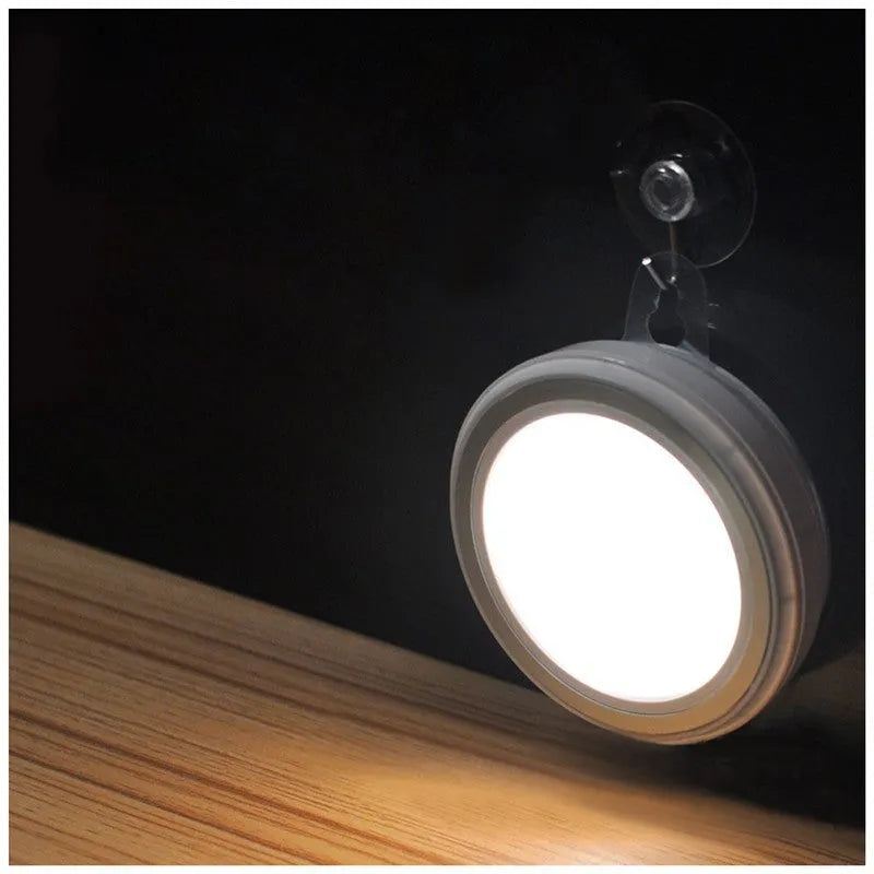 Smart round motion sensor LED light with white housing, shown mounted on a wall.