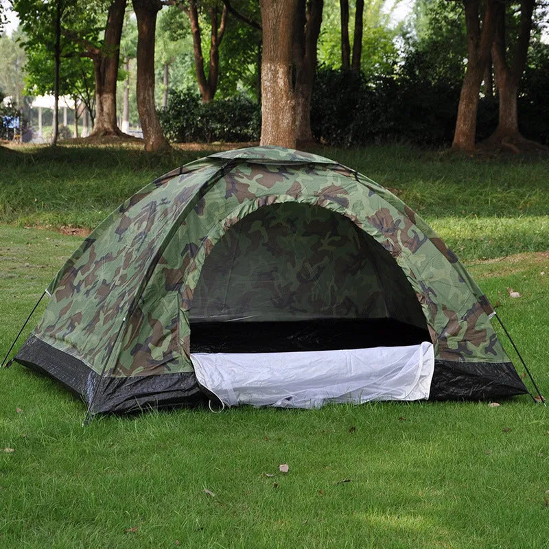 Green camouflage two-person tent with mesh windows and triangular skylight, shown erected outdoors.