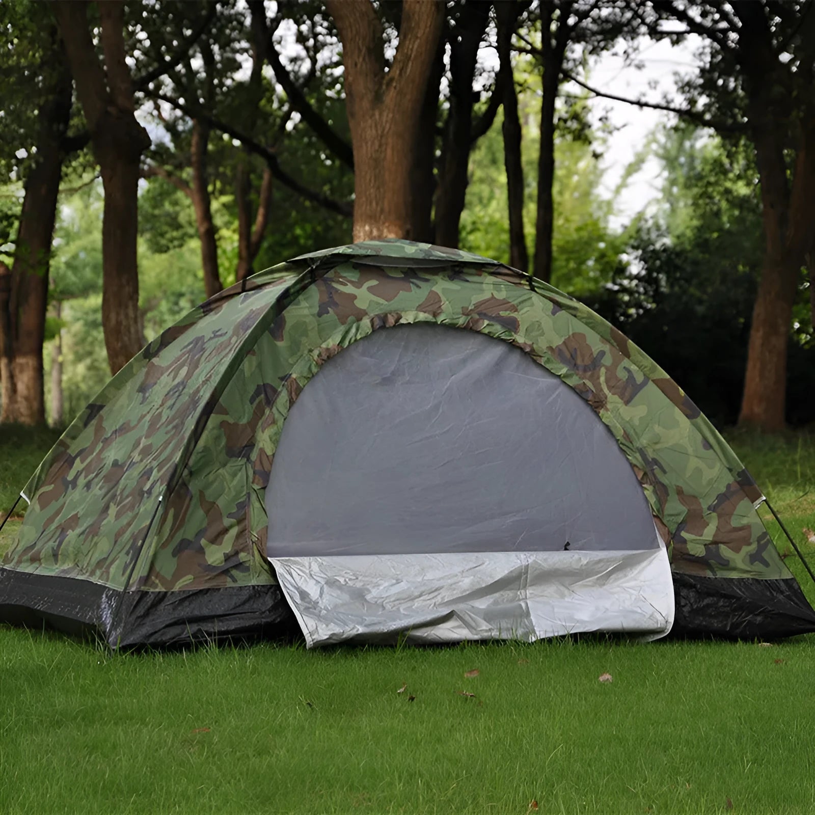Green camouflage two-person tent with mesh windows and triangular skylight, shown erected outdoors.