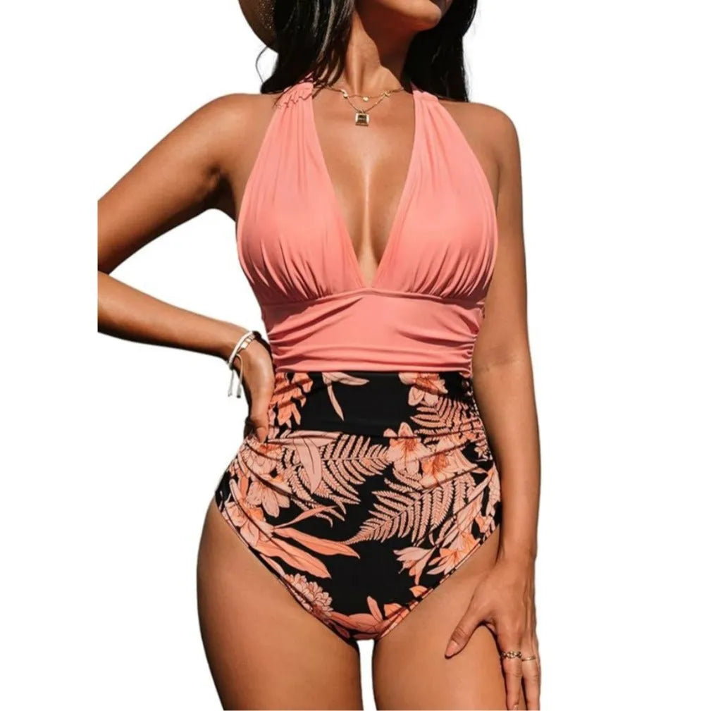 Women's halter neck one-piece swimsuit in a pink floral pattern on a mannequin.