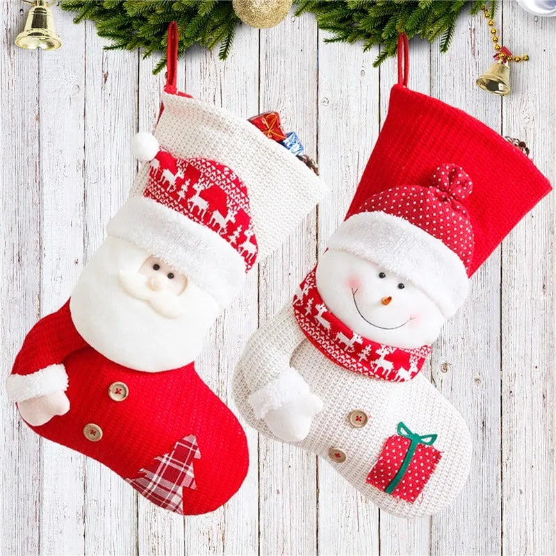 Large red and white knitted Christmas stocking with Santa Claus or Snowman design on a fireplace mantel