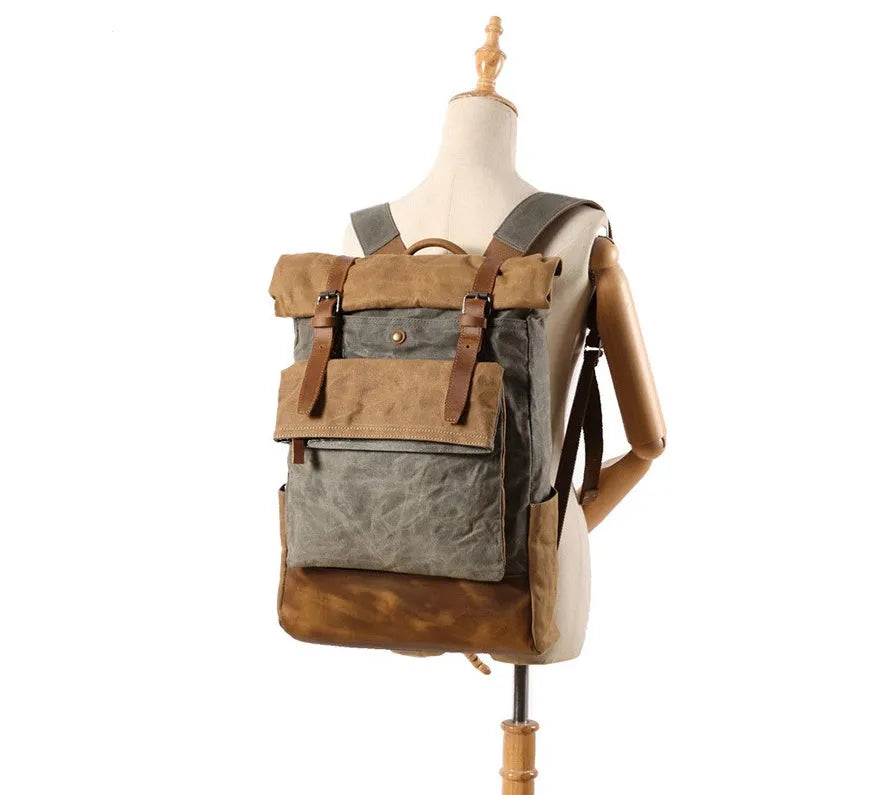 Canvas vintage backpack in khaki showing front zipper pocket and curved shoulder straps with retro square shape