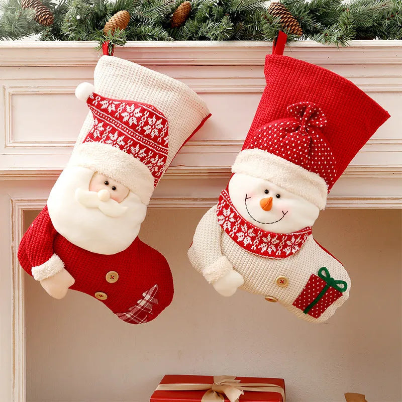 Large red and white knitted Christmas stocking with Santa Claus or Snowman design on a fireplace mantel