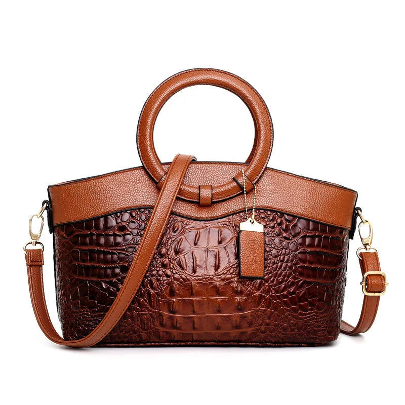 A casual high-quality fabric handbag in a chosen colour, showing the zippered main compartment and front detailing.