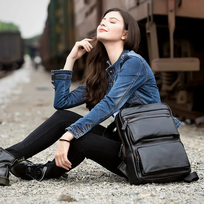 Large black cowhide leather backpack with vertical square shape and shoulder straps
