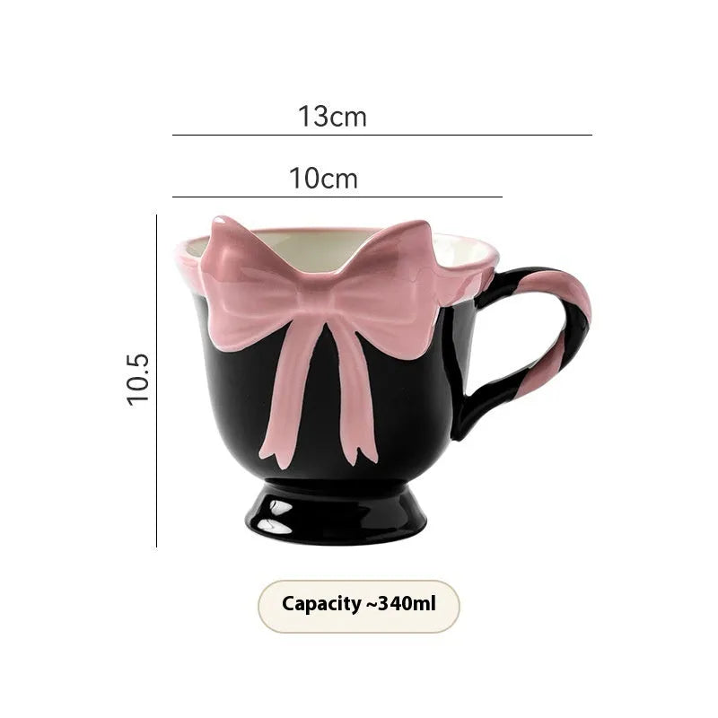 Ceramic mug with heart bow design in white powder and black pink colours.