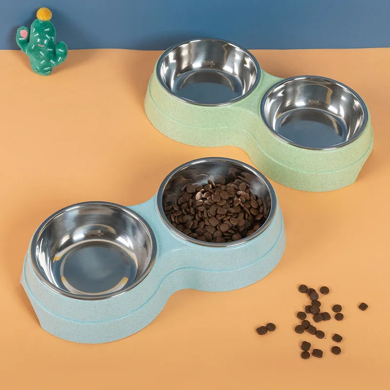 Double pet bowl set with two stainless steel bowls and blue straw holder on white background
